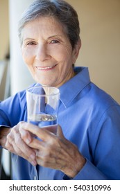 Senior Woman Drinking Water.