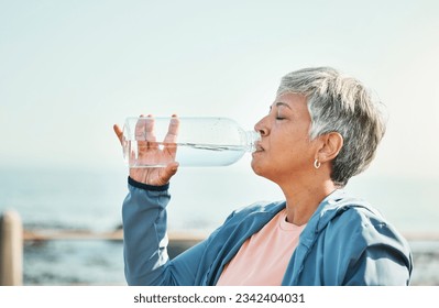 Senior woman, drinking water and health with fitness, hydration and break during workout outdoor. Plastic bottle, liquid and wellness with female athlete at the beach, exercise and training with h2o - Powered by Shutterstock