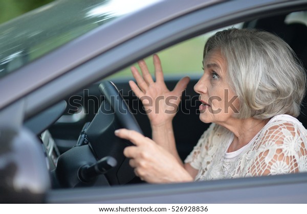 senior woman driving\
car