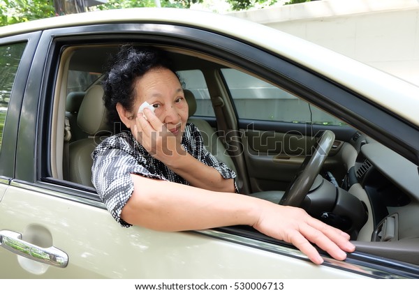 Senior woman driving
car