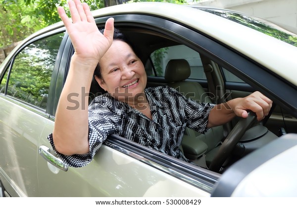 Senior woman driving\
car