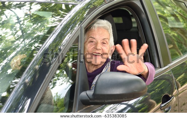senior woman driving a\
car