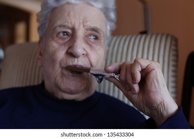 Senior Woman Eating Chocolate Bar