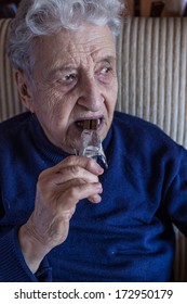 Senior Woman Eating Chocolate Bar