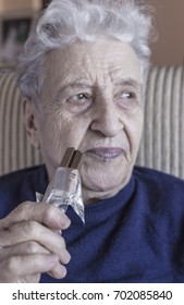 Senior Woman Eating A Chocolate Bar