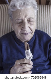 Senior Woman Eating Chocolate Bar