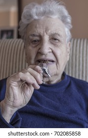 Senior Woman Eating Chocolate Bar