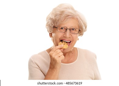 Senior woman eating a cookie isolated on white background - Powered by Shutterstock