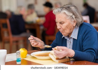 senior woman eating her lunch at home 
