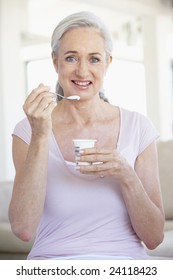 Senior Woman Eating Yogurt