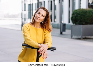 Senior Woman With Electric Scooter In The City