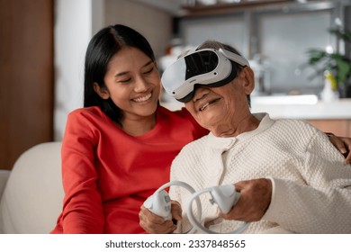 Senior woman enjoying in Metaverse world with young woman at home. Innovation, Metaverse, VR, technology concept. - Powered by Shutterstock