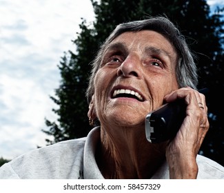 A Senior Woman Enjoys A Conversation On A Cordless Phone.