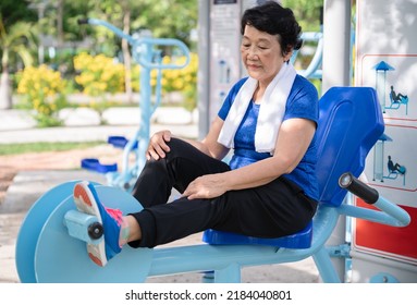 Senior Woman Exercise On Leg Press At Sports Area, Outdoor Gym In The Park 