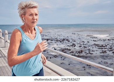 Senior woman, exercise and running at beach promenade, sky mockup or energy of health, wellness and workout. Elderly female, earphones and fitness at ocean of sports, cardio runner and strong mindset - Powered by Shutterstock