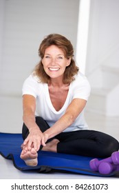 Senior Woman Exercising At Home