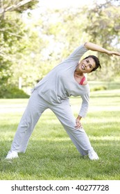 Senior Woman Exercising In Park