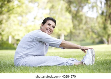 Senior Woman Exercising In Park