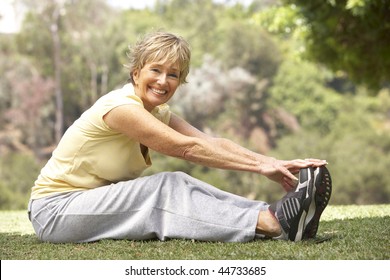 Senior Woman Exercising In Park