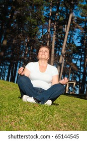 Senior Woman Exercising In Park