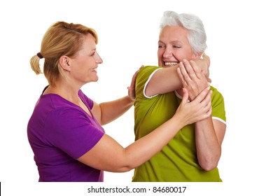 Senior Woman Exercising With Personal Fitness Trainer