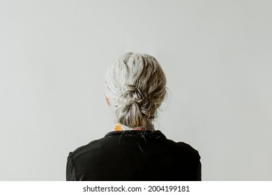 Senior Woman Facing A Gray Wall