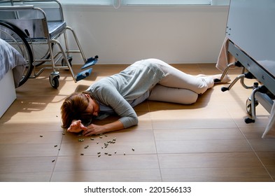 Senior Woman Fall Down At Floor With Spreading Of Medicine Pill In Patient Room.