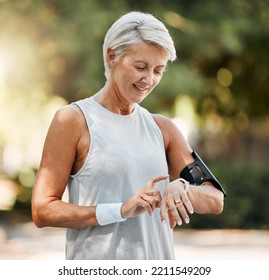 Senior Woman, Fitness And Watch Of Running Time In Health And Wellness For Cardio Exercise In Nature. Active Elderly Female Runner Checking Smartwatch To Monitor Training Results In Sports Workout