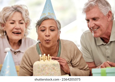 Senior woman, friends and birthday cake for candles, wish and excited with celebration in nursing home. Elderly group, people and together for party, event and blowing flame with retirement - Powered by Shutterstock