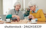 Senior woman, friends and playing chess on table for social activity, decision or strategy game at home. Elderly women enjoying competitive board games for fun bonding together in retirement house