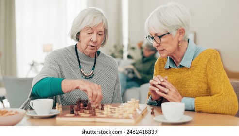 Senior woman, friends and playing chess on table for social activity, decision or strategy game at home. Elderly women enjoying competitive board games for fun bonding together in retirement house - Powered by Shutterstock