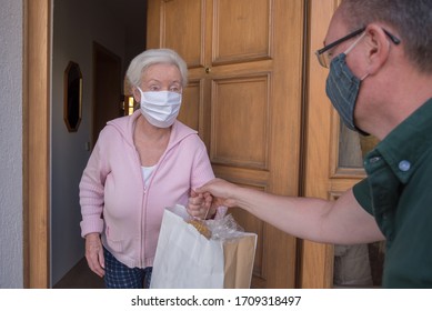 Senior woman gets shopping bag from neighborhood assistance - Shutterstock ID 1709318497