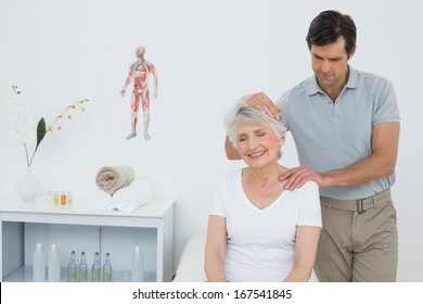 Senior woman getting the neck adjustment done in the medical office - Powered by Shutterstock