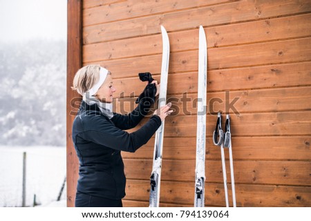 Senior woman getting ready for skiing.