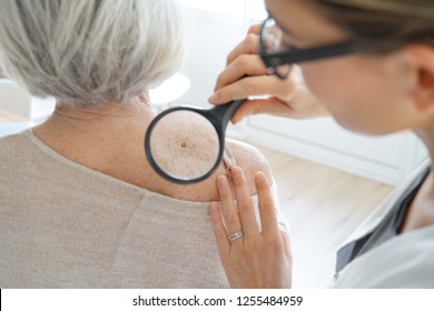  Senior woman getting skin checked by dermatologist                                - Powered by Shutterstock