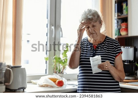 Senior woman going through her receipts at home after buying groceries
 Foto stock © 