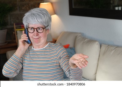 Senior Woman Gossiping Through Retro Landline Portable Phone
