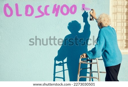 Senior woman, graffiti and wall with spray paint for street art in city, town or metro in retirement. Elderly rebel, painting or pop art in urban outdoor with vandalism, spray or painting in sunshine