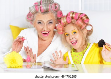 Senior Woman And Granddaughter Doing Make Up