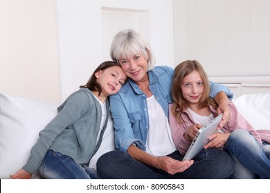 Senior Woman With Grandkids Playing With Touchpad