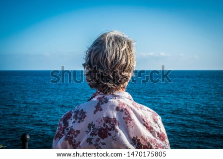 Similar – Senior sportswoman looking at the sea