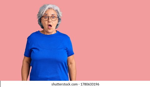 Senior Woman With Gray Hair Wearing Casual Clothes And Glasses Scared And Amazed With Open Mouth For Surprise, Disbelief Face 