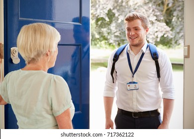 Senior Woman Greeting Male Care Worker Making Home Visit