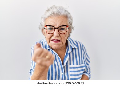 Senior woman with grey hair standing over white background angry and mad raising fist frustrated and furious while shouting with anger. rage and aggressive concept.  - Shutterstock ID 2207944973