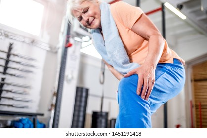 Senior Woman At The Gym Suffering From Pain In Knee