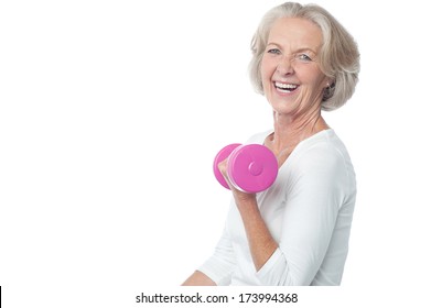 Senior Woman In Gym Working Out With Dumbbells