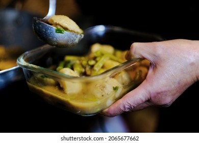 Senior Woman Hands Putting Cooked Potato And Vegetables In Glass Food Container For Grandson School Lunch. Authentic Family Cooking, Love And Bonding Life Background.