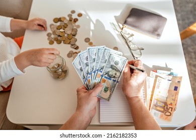 Senior Woman Hands Together With Little Child Counting Money Americain Dollars And Euro At Home Teaching Kid Financial Literacy Planning Family Budget Together