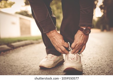 Senior Woman Hands Tying Sneakers. Close Up.