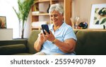 Senior woman, happy and texting on sofa in home with chat, contact or scroll with connection on web. Elderly person, smartphone and smile on couch with click on mobile app for social media in house